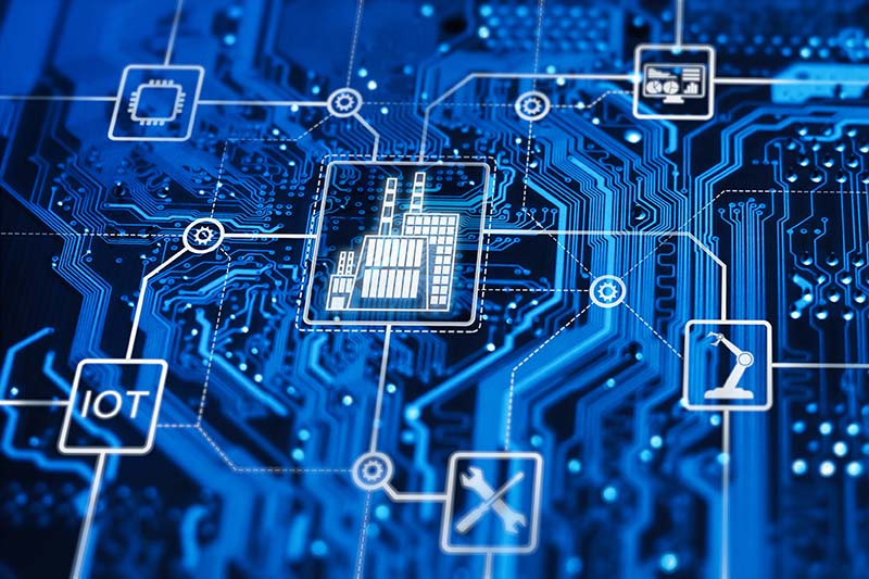 Close-up of a blue circuit board with various digital icons representing the edge capabilities of IoT and industrial automation.