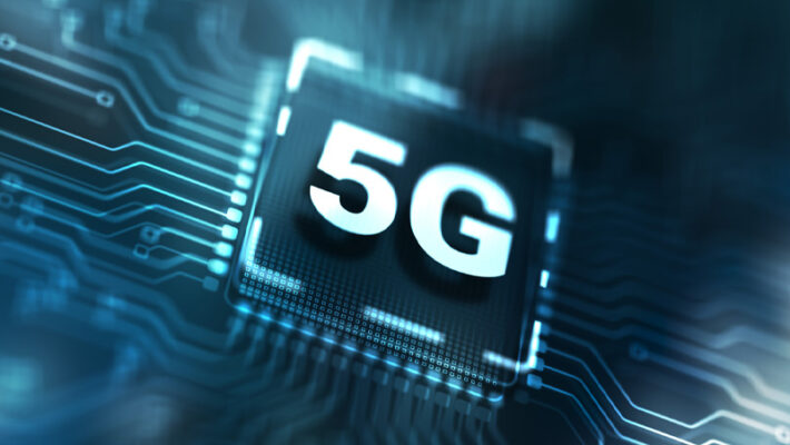 Close-up image of a 5G chip on a circuit board, with glowing blue lines indicating electronic connections and showcasing the intricate details of 5G network slicing.