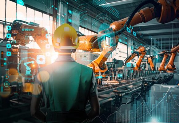 A person in a hard hat observes robotic arms working on an assembly line in a technology-enhanced industrial setting. Digital interfaces and data overlays are visible throughout the process.