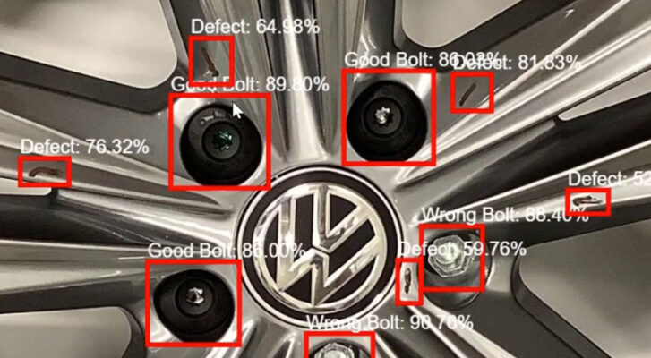 Close-up of a Volkswagen wheel, with bolts and defects highlighted by red boxes, each labeled with identification and percentage values. This demonstrates the power of AI in automotive manufacturing use cases.