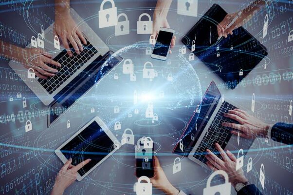 An overhead view of six people using laptops, tablets and smartphones, overlaid with digital padlock icons to represent private 5G security.