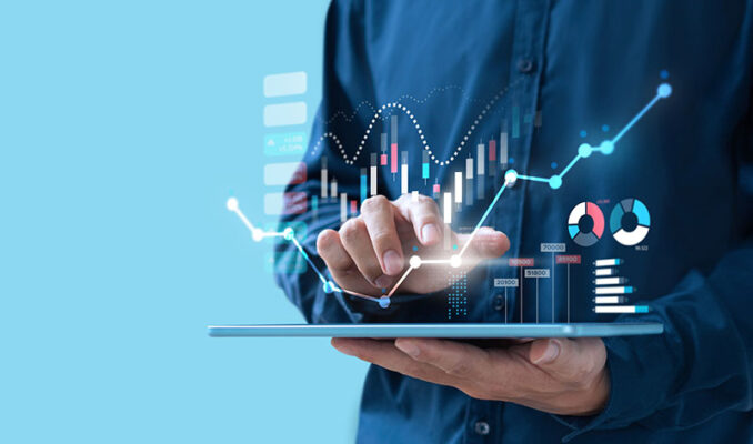 A person engages with data visualizations on a digital screen, including graphs and pie chart.