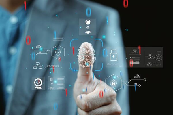 A person in a suit presses a thumb to a digital fingerprint scanner, surrounded by virtual security and data protection icons.