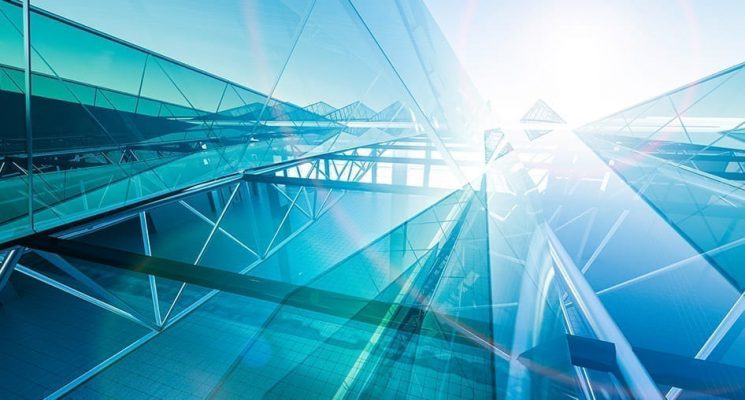 A glass building with the sun shining over the top. IoT vendors and service providers help create the building blocks of an overall solution that will help an organization realize its business objectives.