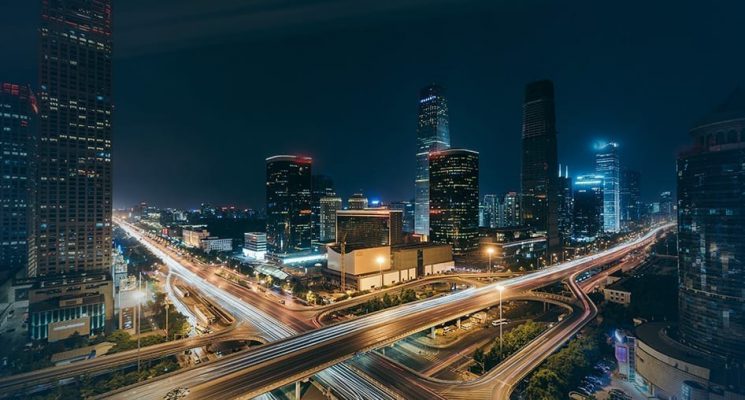 View of a busy city at night. C-band spectrum generates frequency to support applications that require high data throughput (e.g., smartphones and industrial and home gateways).