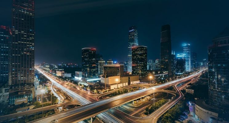 View of a busy city at night. C-band spectrum generates frequency to support applications that require high data throughput (e.g., smartphones and industrial and home gateways).