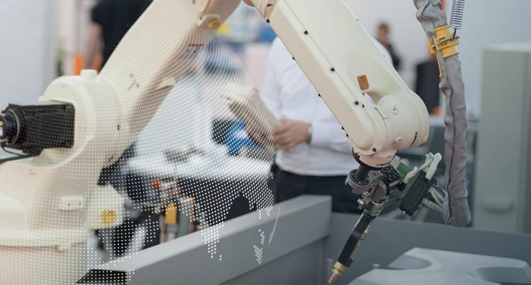 A robotic arm in a manufacturing plant overlaid with a partial globe made of dots.
