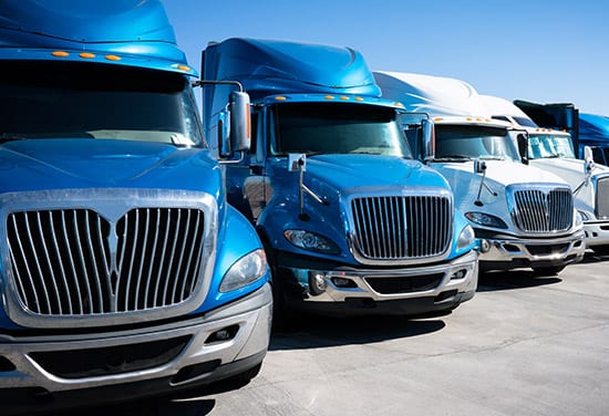 A fleet of semi trucks parked.