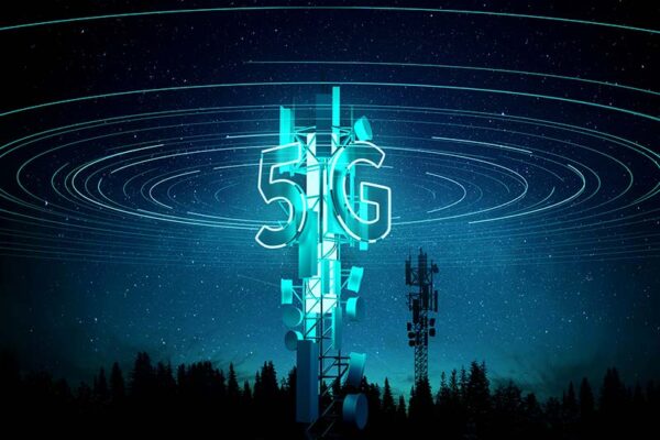 A nighttime view of a cell tower with 5GT superimposed in front of it and curved lines emanating from the top