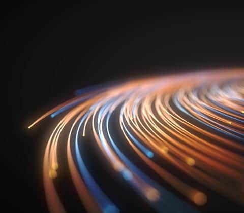 A blurry image of a light trail on a black background.