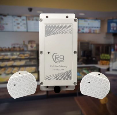 A white device is sitting on a counter in a restaurant.