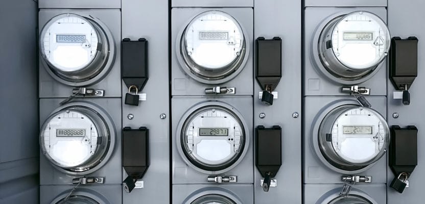 A row of smart meters in a metal building.