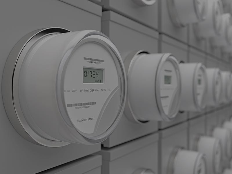 A row of digital meters on a wall.