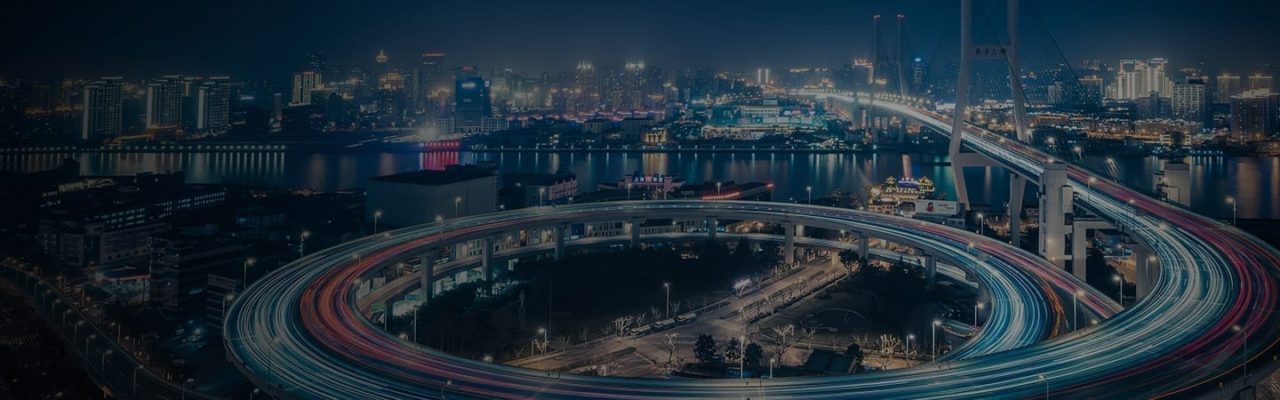 An image of a city at night with a bridge.