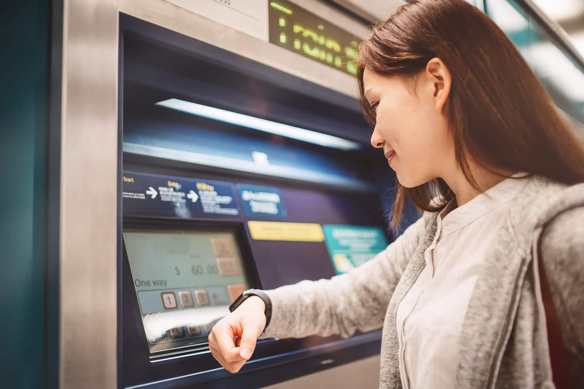 A woman is using a smart ATM machine.