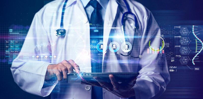 A doctor holds a laptop, which is receiving health care data.