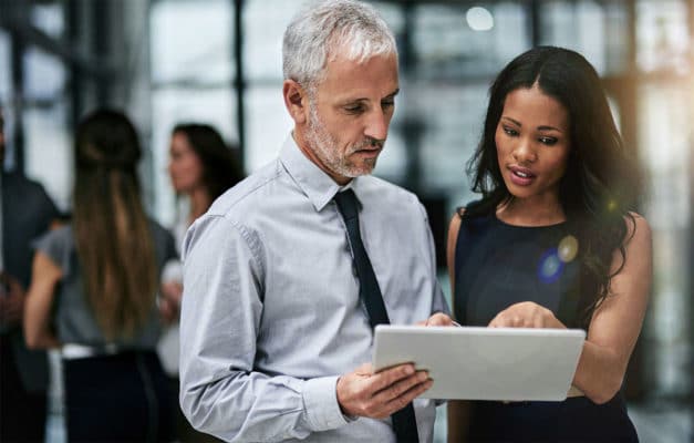 Two business people looking at a tablet.