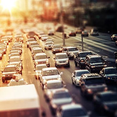 A blurry image of traffic in a city, showcasing the challenges of urban transport.