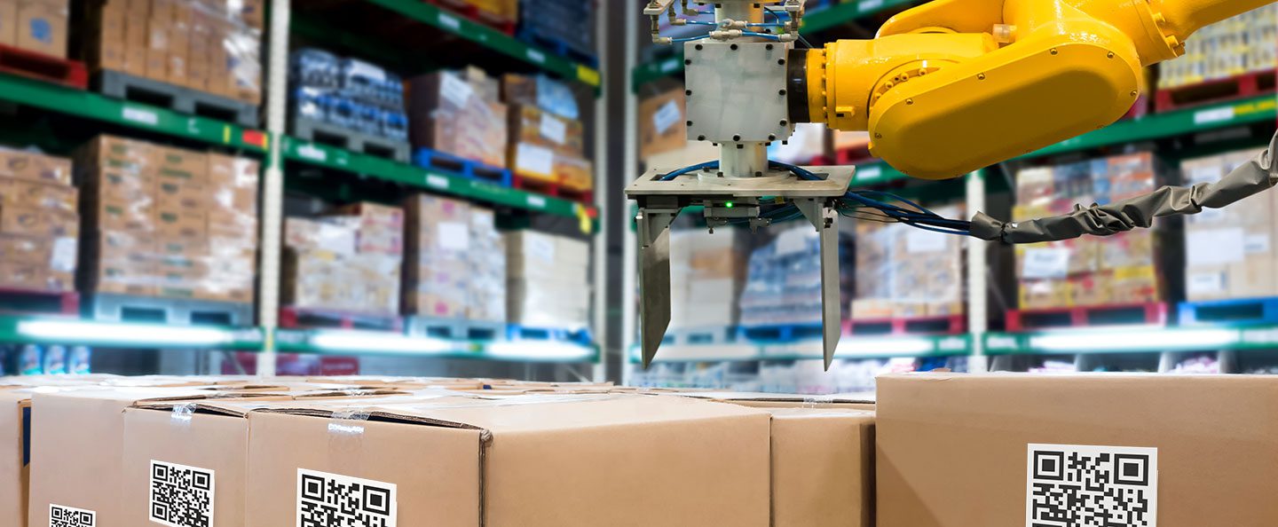 A robot is managing the supply chain in a warehouse by moving boxes.