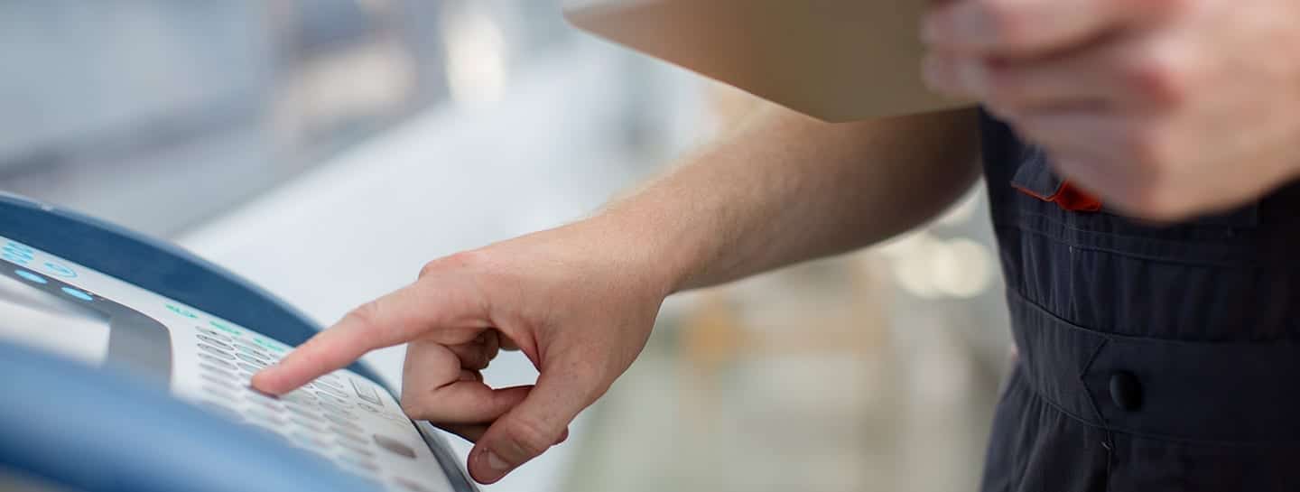 A man is pointing at an IoT asset tracking machine.