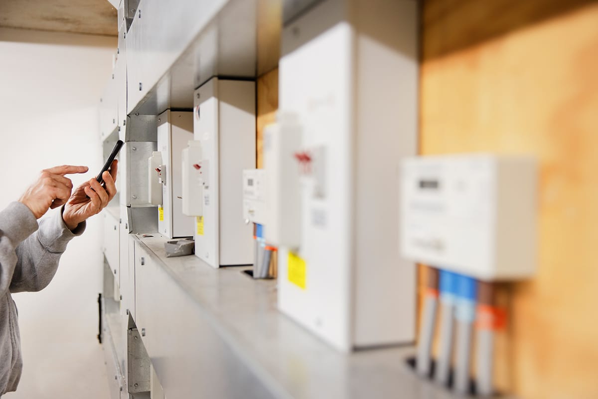 A man is examining IoT utilities in a room.