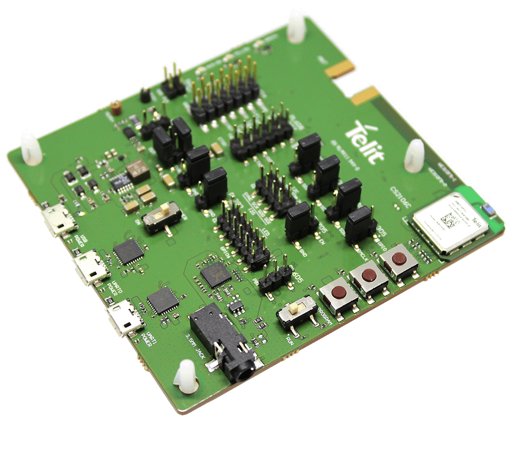 A green board with a number of electronic components on it.