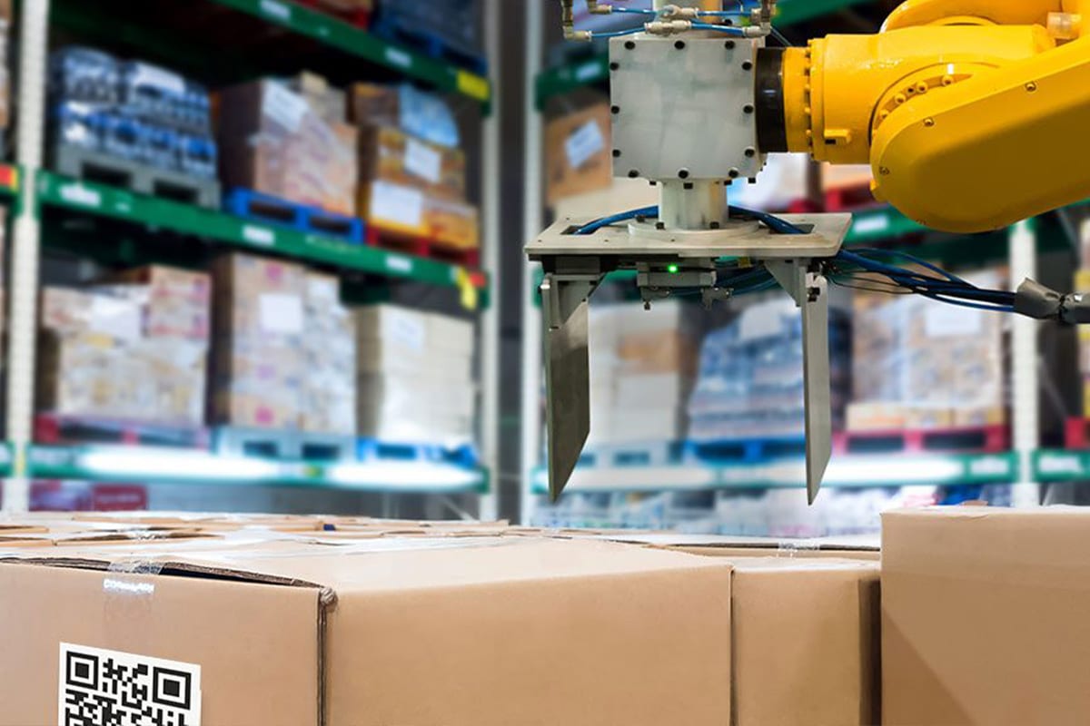 A robot is handling boxes in a warehouse for supply chain management purposes.