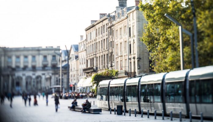 A tram going through a city.