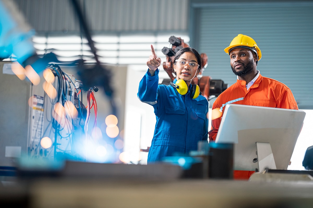 Two workers in a factory.