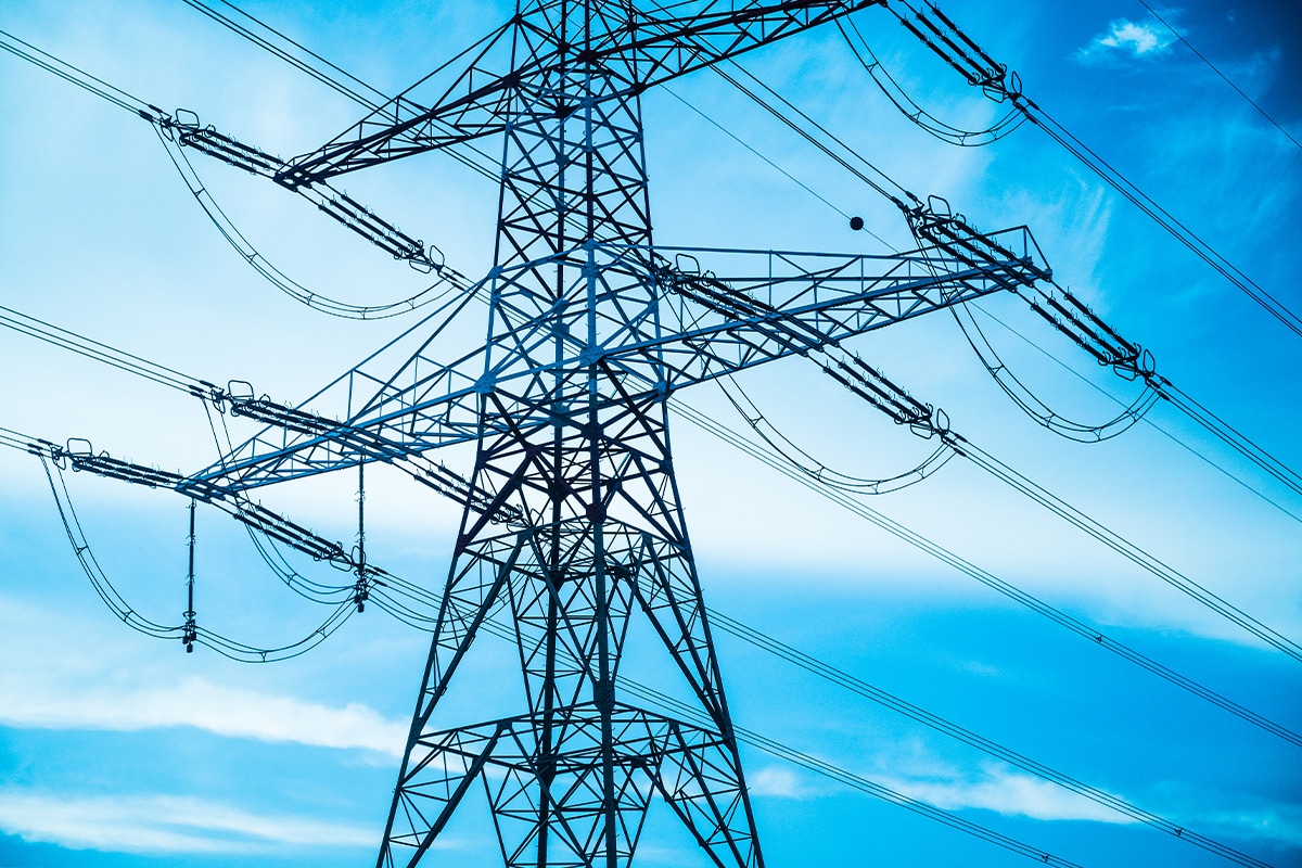 A high voltage pylon against a blue sky.