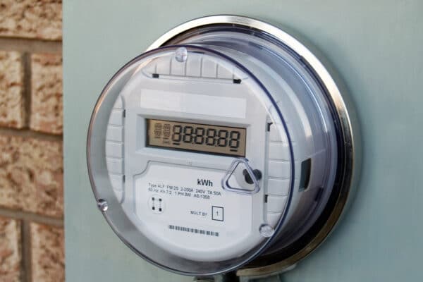 A smart meter attached to a flat wall.