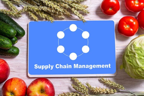 Supply chain management on a table with vegetables and fruits.