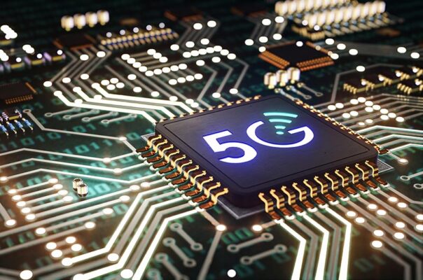 A close-up view of a 5G microchip mounted on a lit-up circuit board.