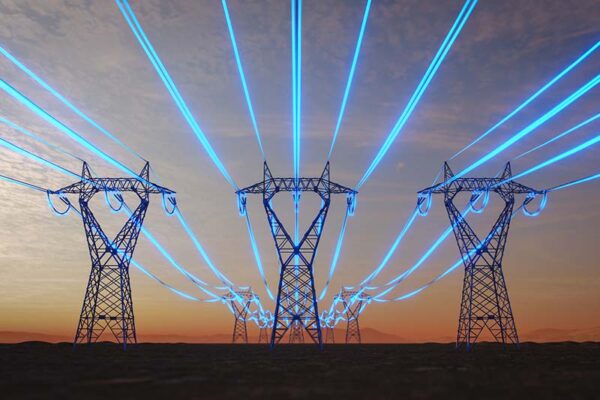 Glowing blue power lines run through electrical transmission towers.