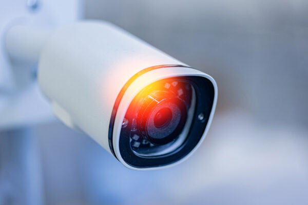 A CCTV camera equipped with a red light, commonly used in surveillance systems.