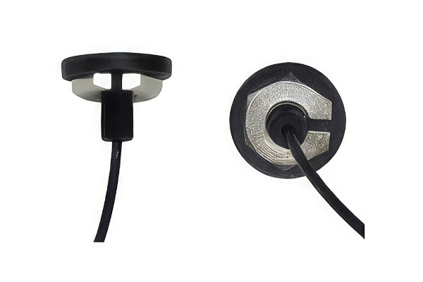 Two views of a black, round magnetic mount with a cable attached, shown from the side and from above against a white background.