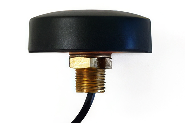 A close-up side view of a black, dome-shaped antenna with a brass threaded base and an attached black cable against a white background.