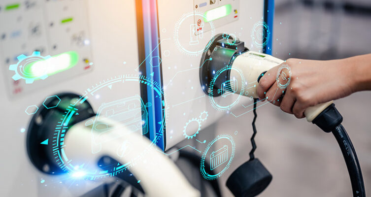 A hand plugs an EV charging cable into a station, with various technology icons and diagrams overlaid on the image.