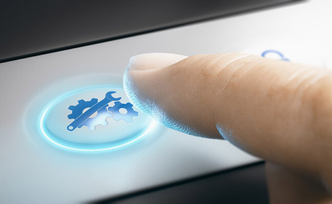A finger pressing a button with a gear and wrench icon, symbolizing technical settings or system maintenance.