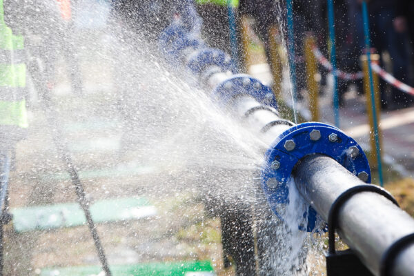 A pipe with a severe water leak. WaterSignal's water monitoring an leak prevention system is enabled with IoT connectivity to prevent water loss and attached costs.