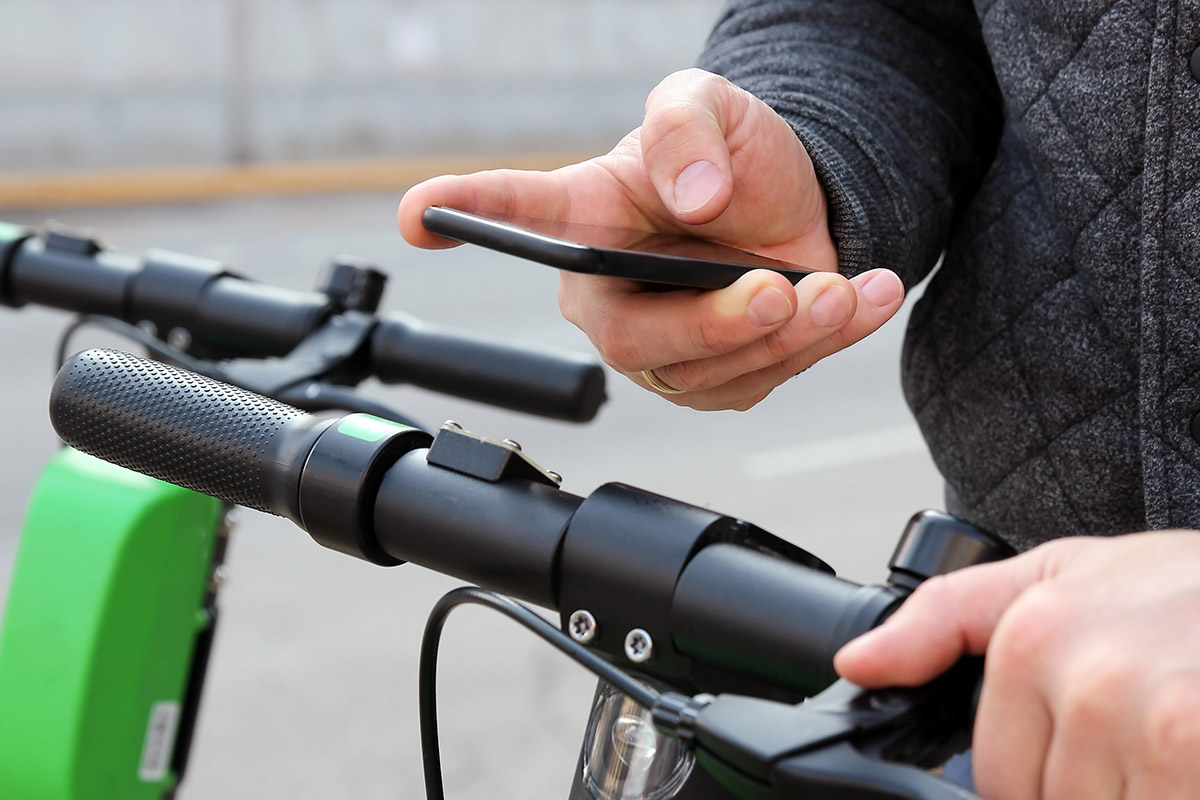 A person riding a bicycle while using a cell phone.