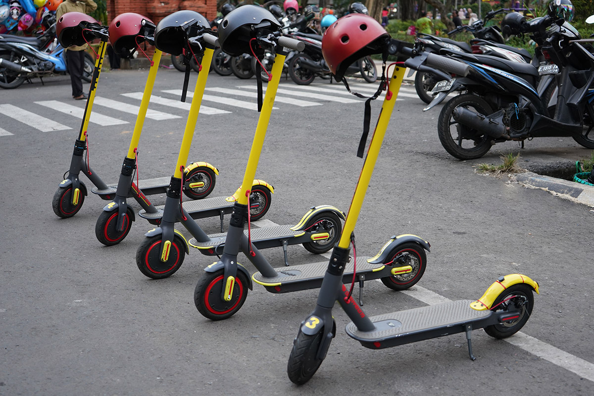 A cluster of IoT-enabled scooters parked on a street.