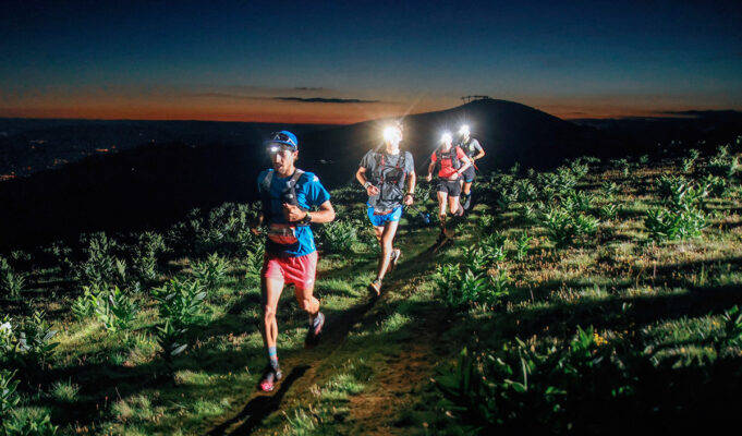 A group of people running at night.