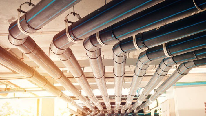 A group of pipes in a building designed for smart water management.