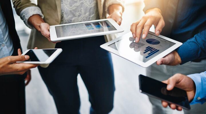 Businesspeople using their wireless devices in the office.