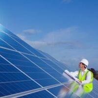 An engineer inspecting solar panels.