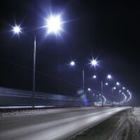 Smart street lighting along a city highway at night.