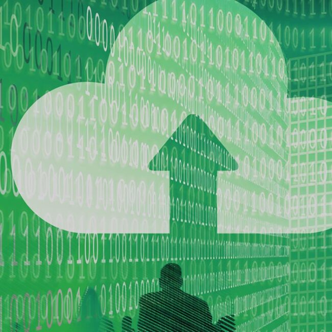 A person sitting at a desk, surrounded by ones and zeros with a symbol indicating uploading data to the cloud superimposed above them.