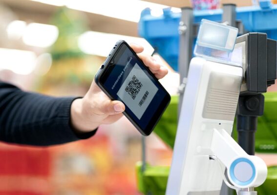 Person using a smartphone to pay with a QR Code.