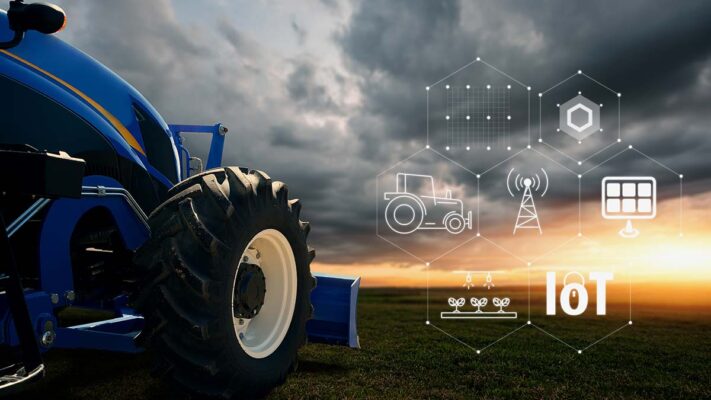 A tractor in a field next to icons in a honeycomb shape indicating IoT and smart agriculture.